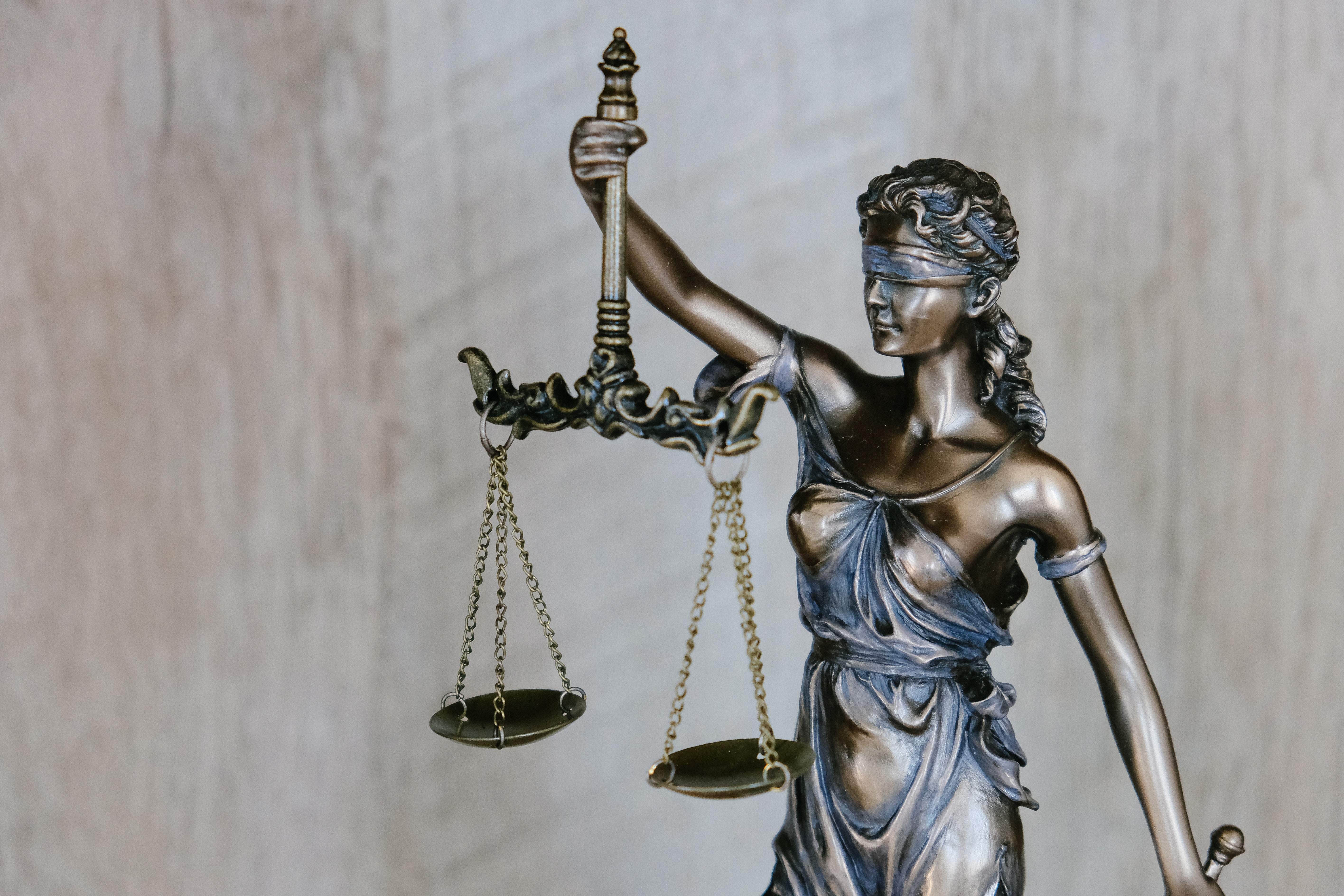 Lady Justice statue holding scales, symbolizing truth and justice